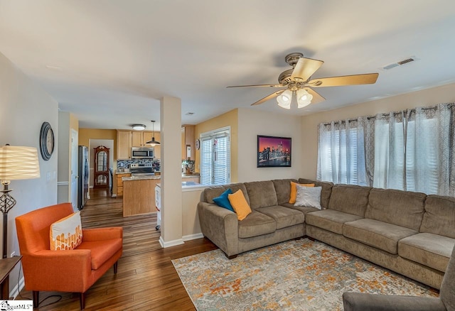 living room featuring dark hardwood / wood-style floors and ceiling fan