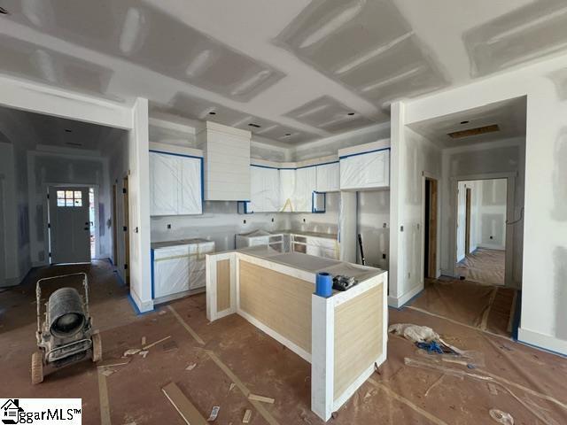 kitchen with a center island and white cabinetry