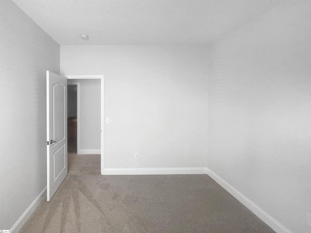 empty room featuring carpet flooring