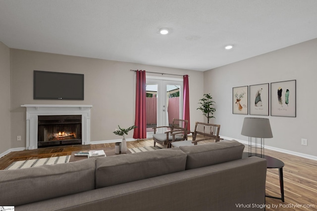 living room with french doors and hardwood / wood-style flooring