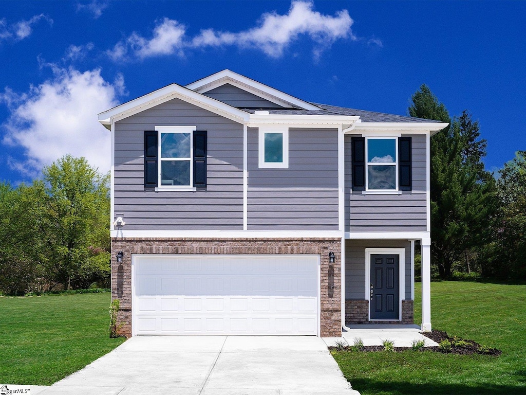 view of front of property featuring a garage and a front lawn