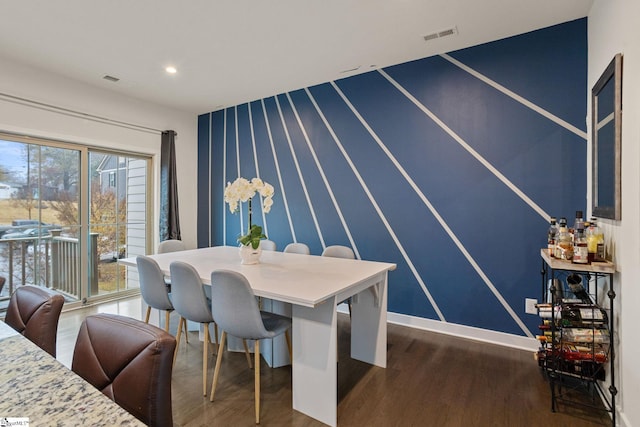 dining space with dark hardwood / wood-style flooring