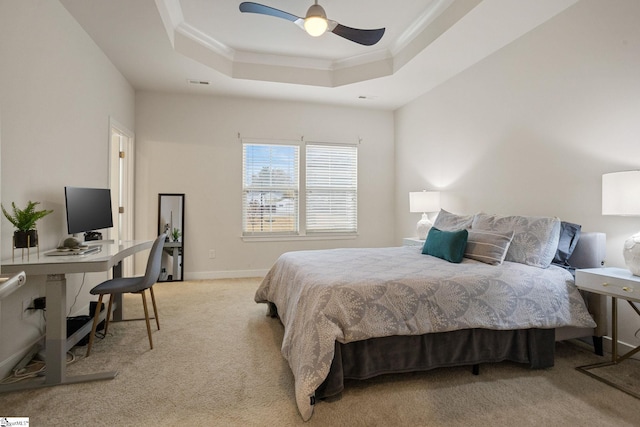 bedroom with a tray ceiling, light carpet, ceiling fan, and ornamental molding