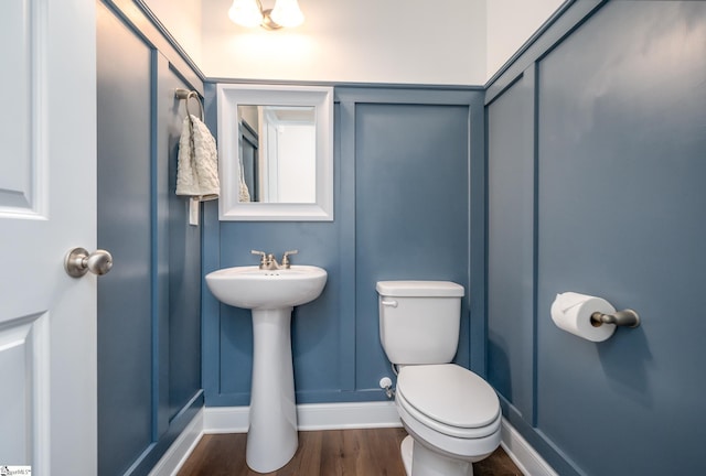 bathroom featuring hardwood / wood-style floors and toilet