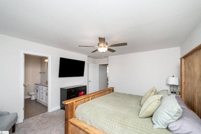 bedroom with ceiling fan, carpet floors, and connected bathroom