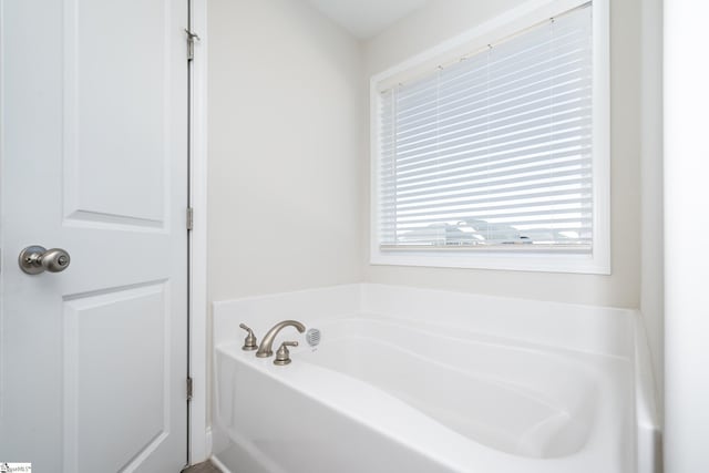 bathroom featuring a tub to relax in