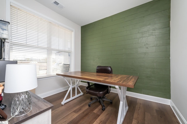 office space with wooden walls and dark hardwood / wood-style floors