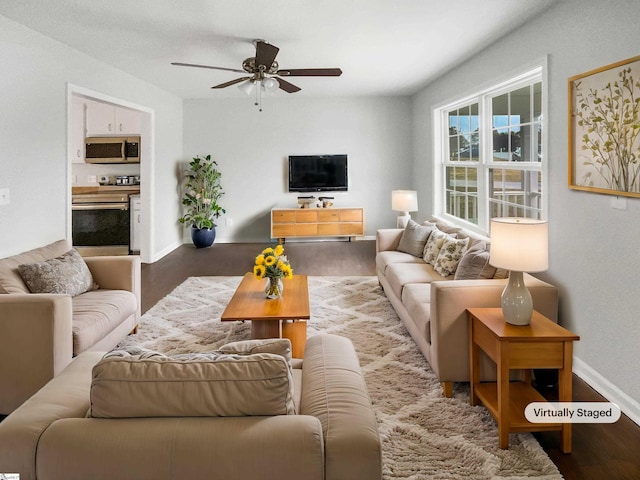 living room with ceiling fan and hardwood / wood-style flooring