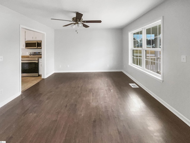 empty room featuring dark hardwood / wood-style flooring and ceiling fan