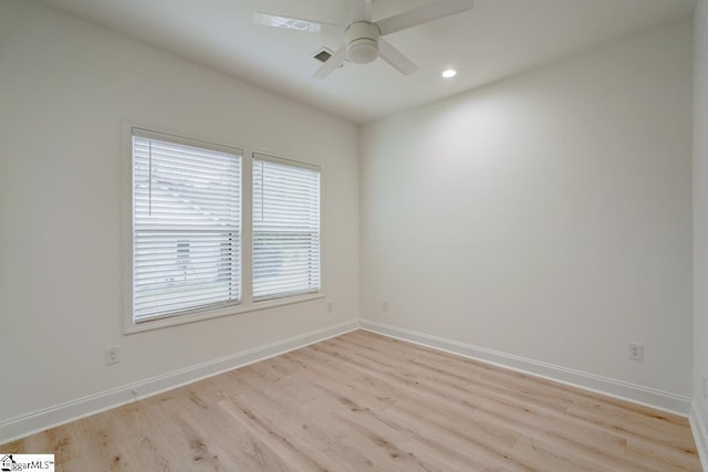 empty room featuring ceiling fan and light hardwood / wood-style flooring