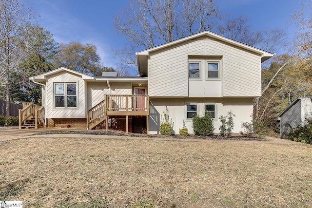 back of house with a wooden deck