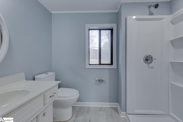 bathroom with a shower, vanity, hardwood / wood-style flooring, and crown molding