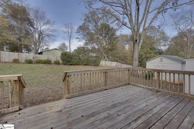 deck with a lawn and a storage shed