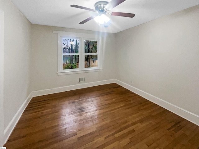 empty room featuring ceiling fan and dark hardwood / wood-style floors