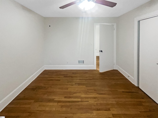 unfurnished room featuring ceiling fan and dark hardwood / wood-style flooring