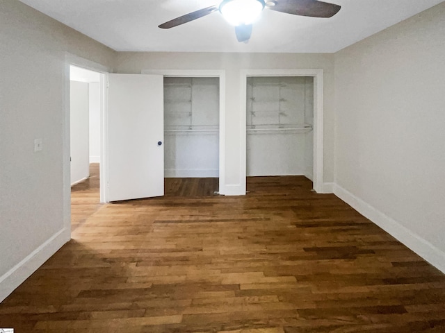 unfurnished bedroom with ceiling fan and dark hardwood / wood-style floors