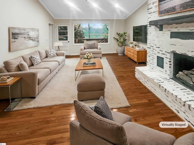 living room with hardwood / wood-style flooring, crown molding, and lofted ceiling