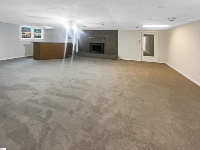 basement featuring carpet flooring and a fireplace