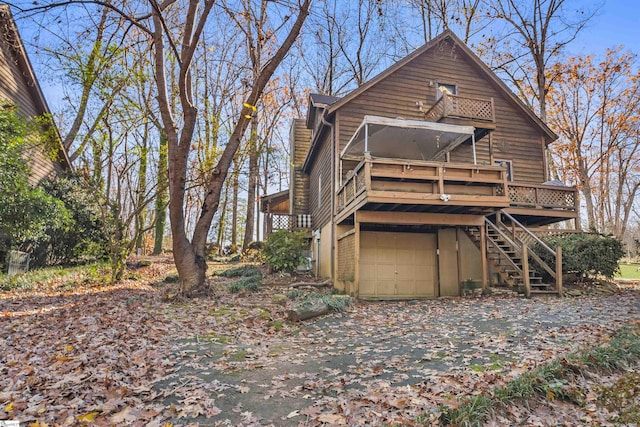 back of property with a garage and a deck