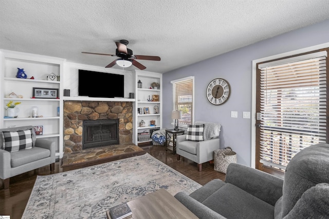 living room featuring a textured ceiling, a wealth of natural light, and dark wood-type flooring