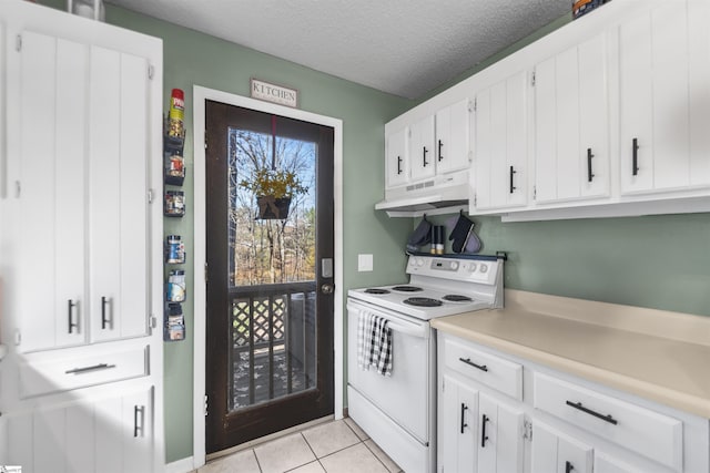 kitchen featuring a textured ceiling, white cabinetry, white electric stove, and light tile patterned floors