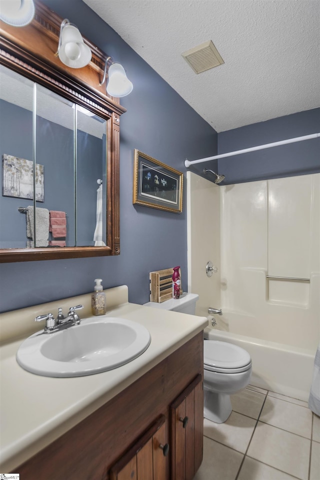 full bathroom featuring tile patterned floors, vanity, a textured ceiling, bathing tub / shower combination, and toilet