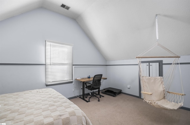 carpeted bedroom with lofted ceiling