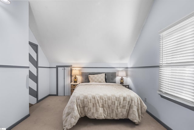 carpeted bedroom featuring vaulted ceiling