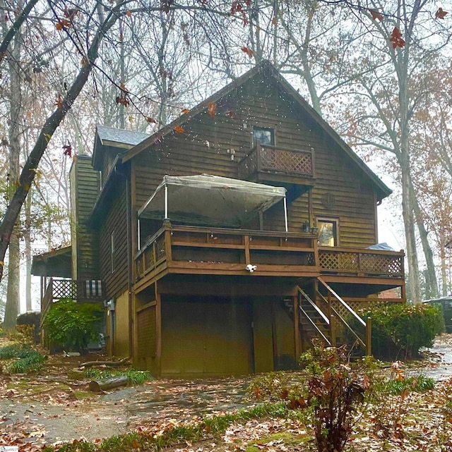 rear view of property featuring a wooden deck