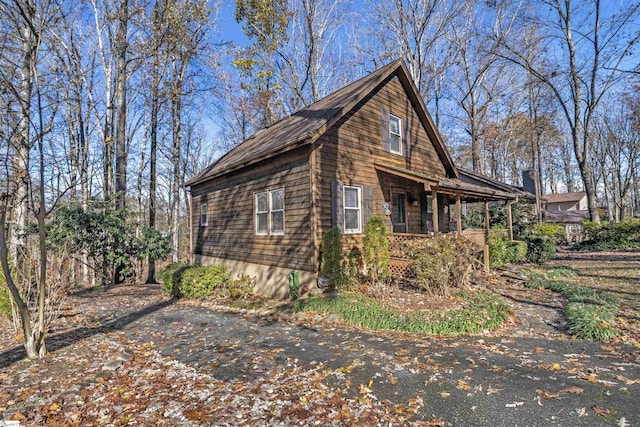 view of side of home with covered porch