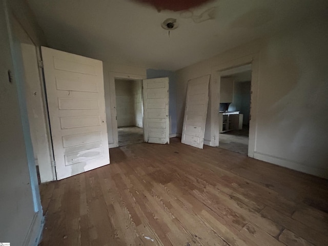 unfurnished bedroom with wood-type flooring