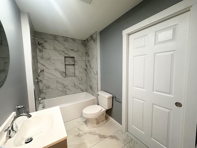 full bathroom with toilet, vanity, and tiled shower / bath