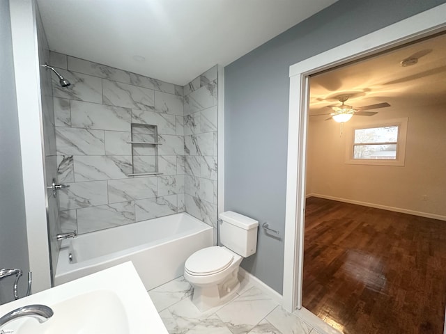 full bathroom with hardwood / wood-style floors, sink, tiled shower / bath combo, ceiling fan, and toilet