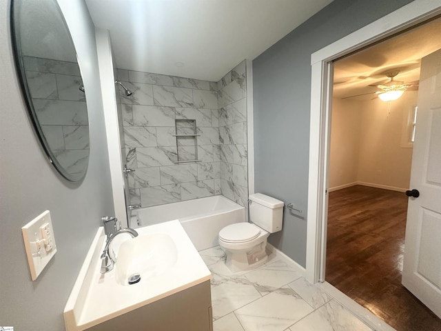 full bathroom with ceiling fan, toilet, hardwood / wood-style flooring, vanity, and tiled shower / bath