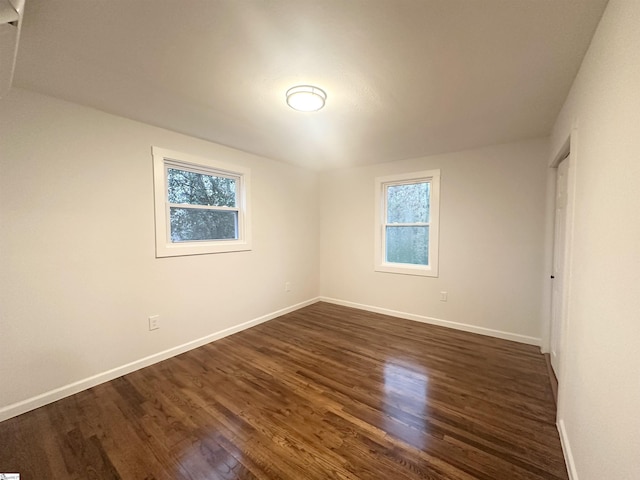 unfurnished room with dark hardwood / wood-style floors