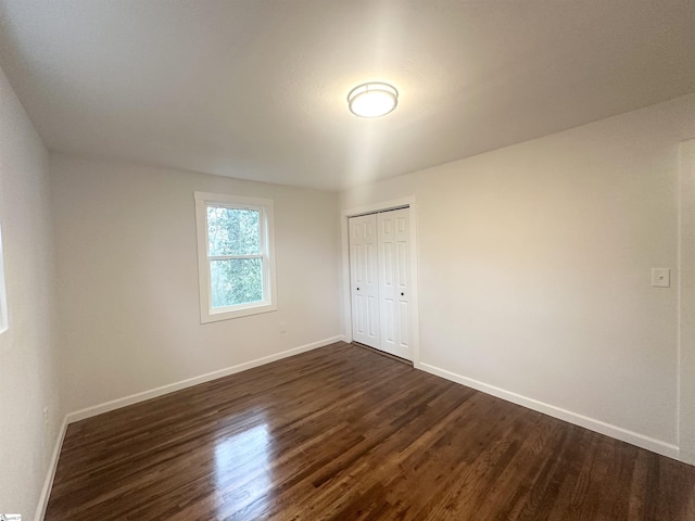 spare room with dark hardwood / wood-style floors