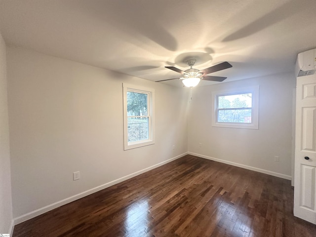 unfurnished room featuring dark hardwood / wood-style flooring, an AC wall unit, and ceiling fan