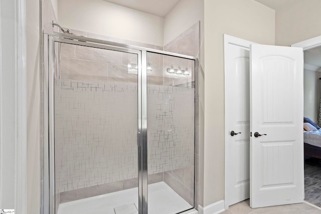 bathroom with tile patterned floors and a shower with shower door