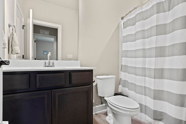 bathroom featuring tile patterned flooring, vanity, and toilet