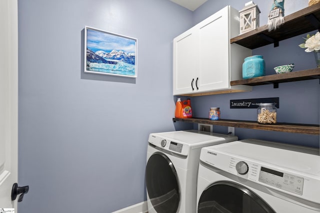 washroom featuring cabinets and washing machine and clothes dryer