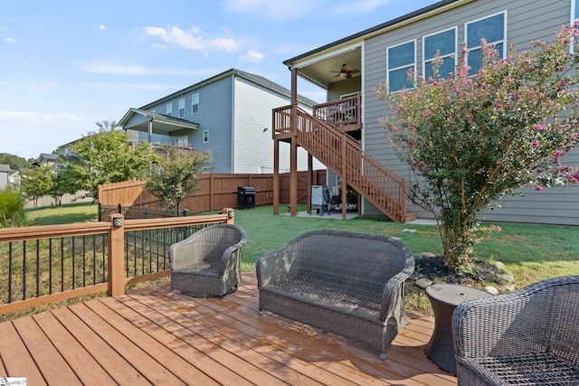 wooden deck with a lawn, ceiling fan, and a grill