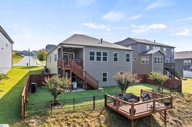 back of house featuring a deck and a yard