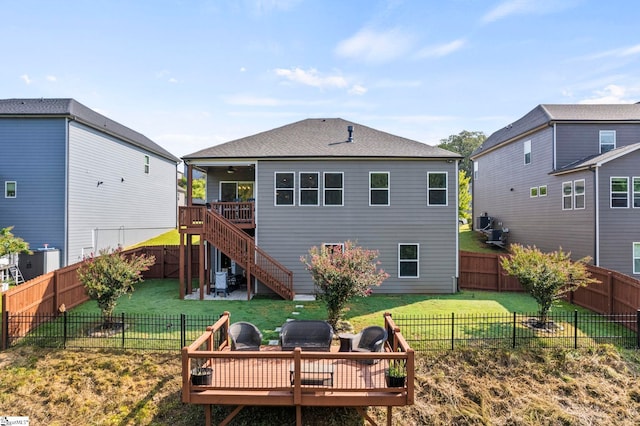 back of house featuring an outdoor living space, a yard, and a deck