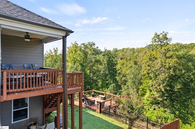 wooden terrace with a lawn, ceiling fan, and central AC