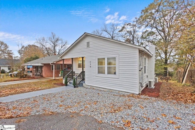 bungalow featuring ac unit and covered porch