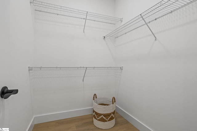 spacious closet featuring hardwood / wood-style flooring