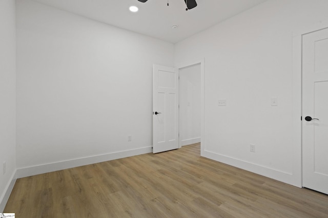 empty room featuring light wood-type flooring and ceiling fan