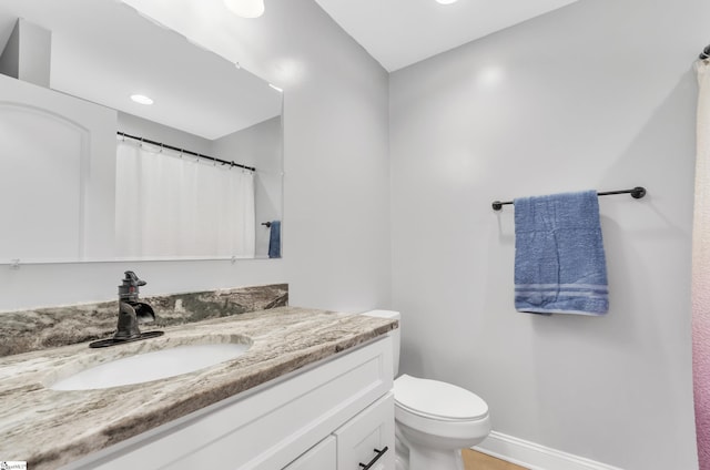 bathroom with vanity and toilet