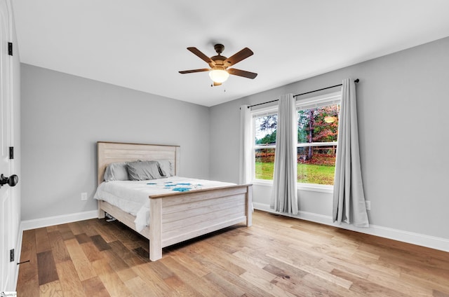 bedroom with ceiling fan and light hardwood / wood-style floors