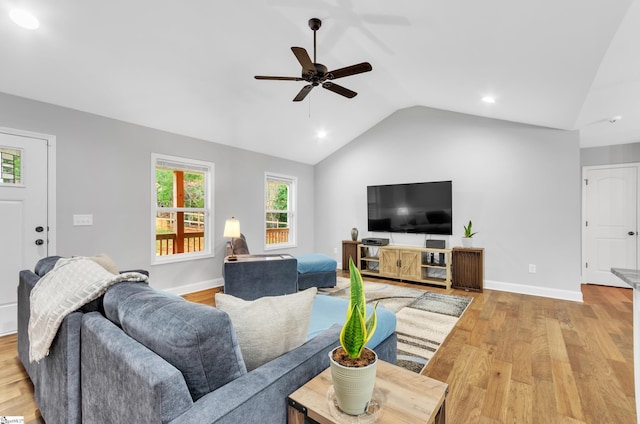 living room featuring ceiling fan, light hardwood / wood-style flooring, and lofted ceiling